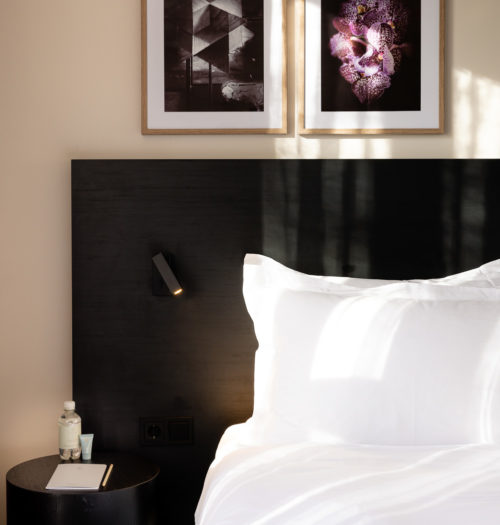 Bed with art frames at Pillows Hotels Deventer