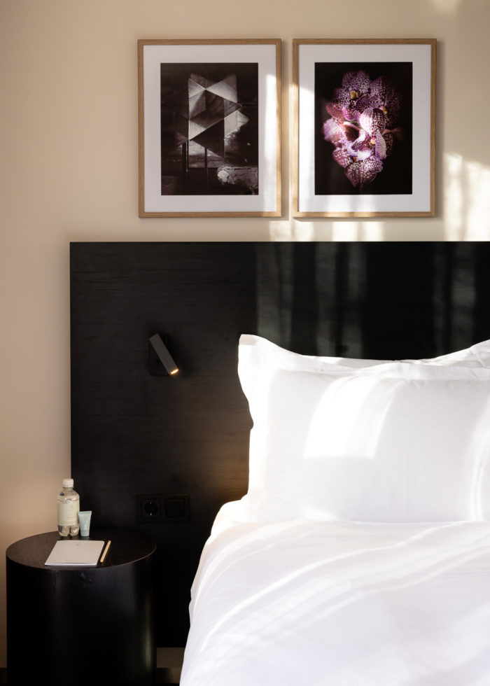 Bed with art frames at Pillows Hotels Deventer