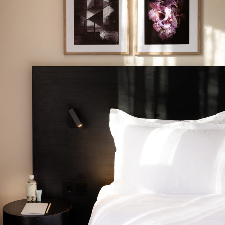 Bed with art frames at Pillows Hotels Deventer