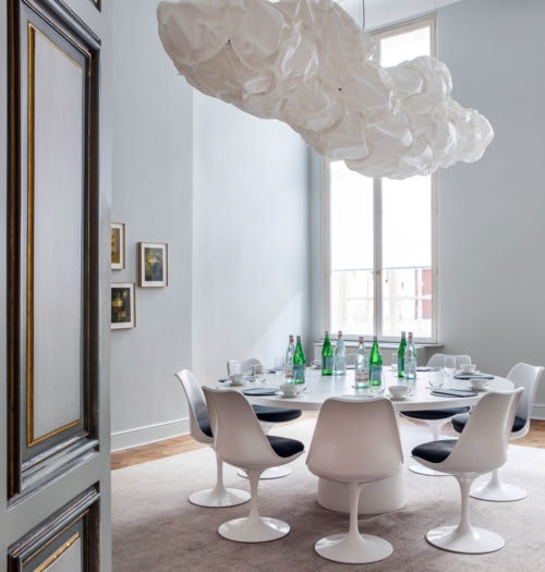 A bright meeting room with a white round table and white chairs in Pillows Hotel Reylof in Ghent