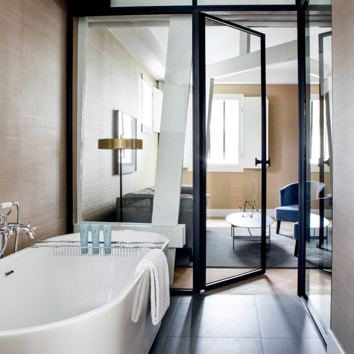 A white bath tube in a hotel suite