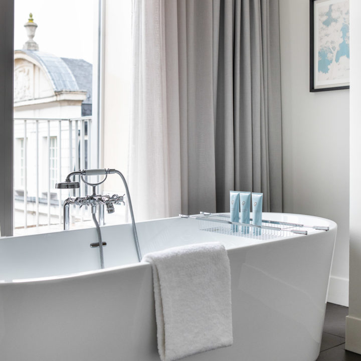 A modern white bath tube in a hotel room