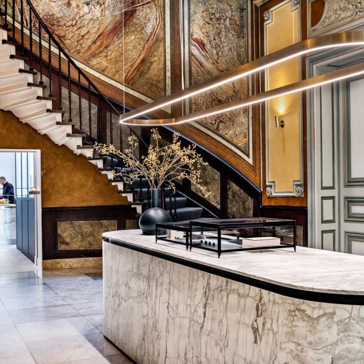 The hotel lobby of Pillows hotel Reylof in Ghent with marble desk