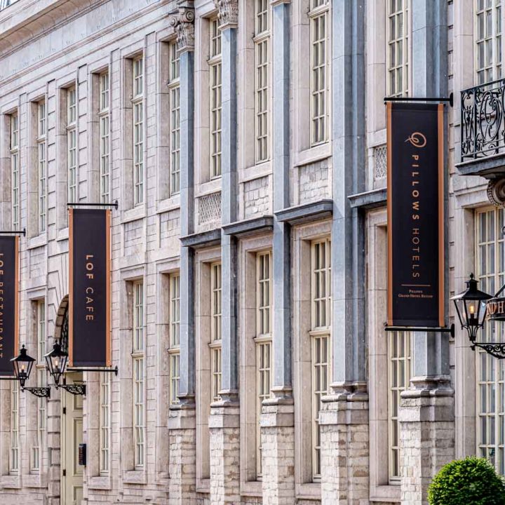 The outside of Pillows Hotel Reylof in Ghent with black banners