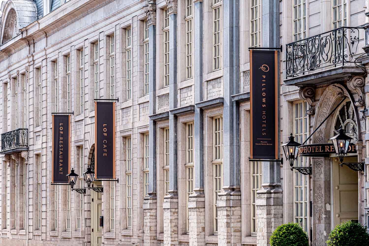 The outside of Pillows Hotel Reylof in Ghent with black banners