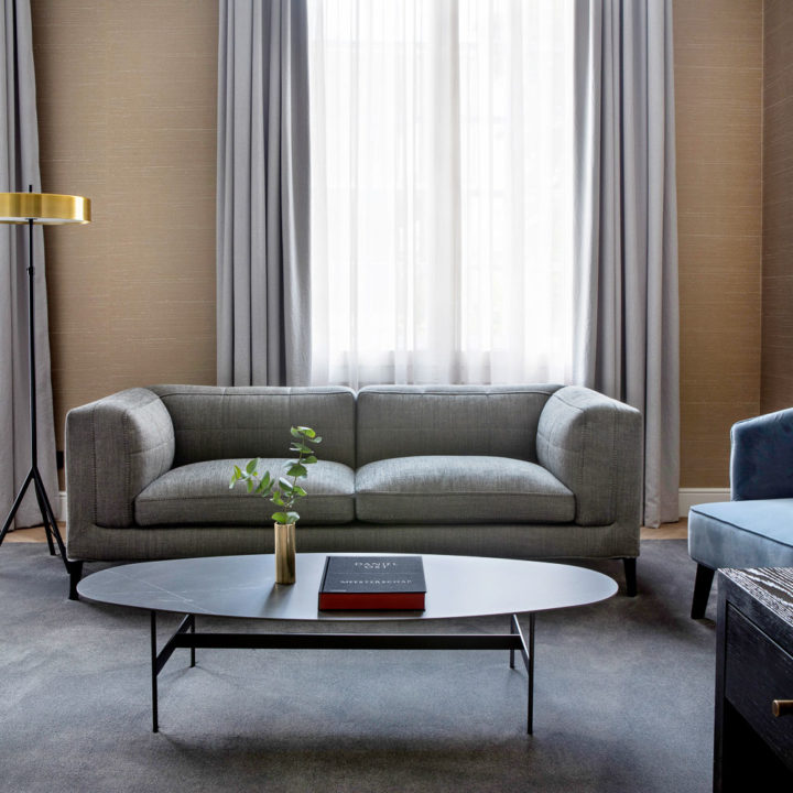 A grey couch in the Suite of Pillows Grand Hotel Reylof in Ghent